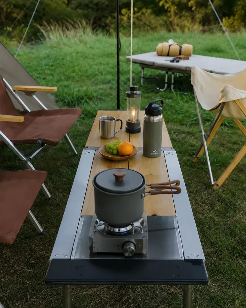 Camping A well-equipped campsite with a camping table, folding chairs, lanterns, and cookware showcases a practical range of camping gear in China.