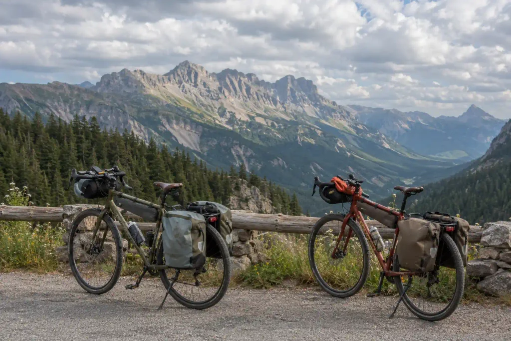 cycling Touring bicycles fitted with bike bags and cycling accessories at a mountain viewpoint.