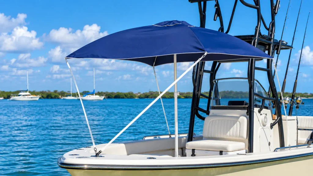 Blue boat umbrella with a center support pole and tension straps providing shade on a fishing boat